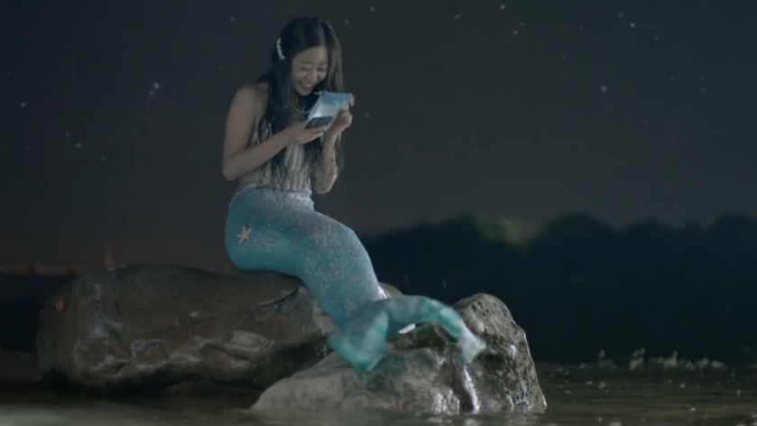 cellphone, even the modern mermaid is jacked in to the latest tech